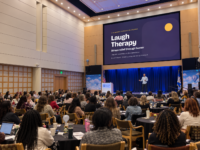 Bruce Brilliance on stage presenting Laugh Therapy: stress relief through humor at Hennepin County’s Still We Rise conference