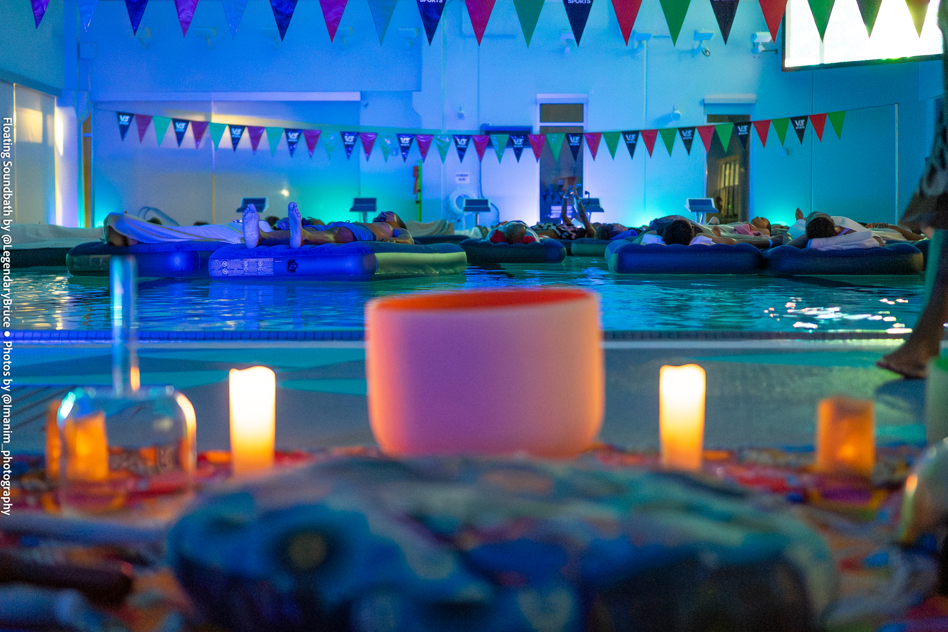 Candles and a crystal singing bowl beside the pool at Floating Soundbath MPLS