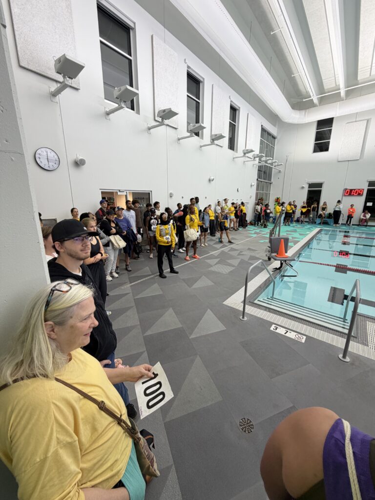 Athletes and spectators on the V3 Sports pool deck during the triathlon swim