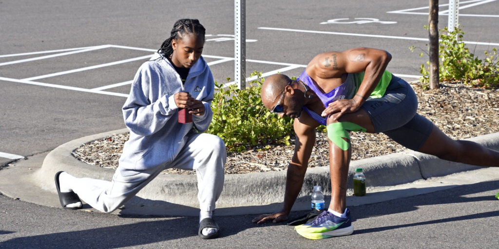 Bruce Leroy Williams stretching with an athlete before the Push Triathlon