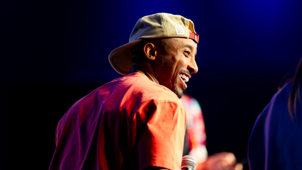 Bruce Brilliance laughing on stage at the ASICS Twin Cities Game Show